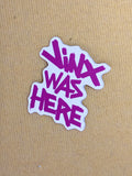 Sticker with 'Jinx Was Here' text on a beige background