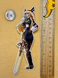 Sticker of a character with a sword next to a ruler for scale on a textured surface